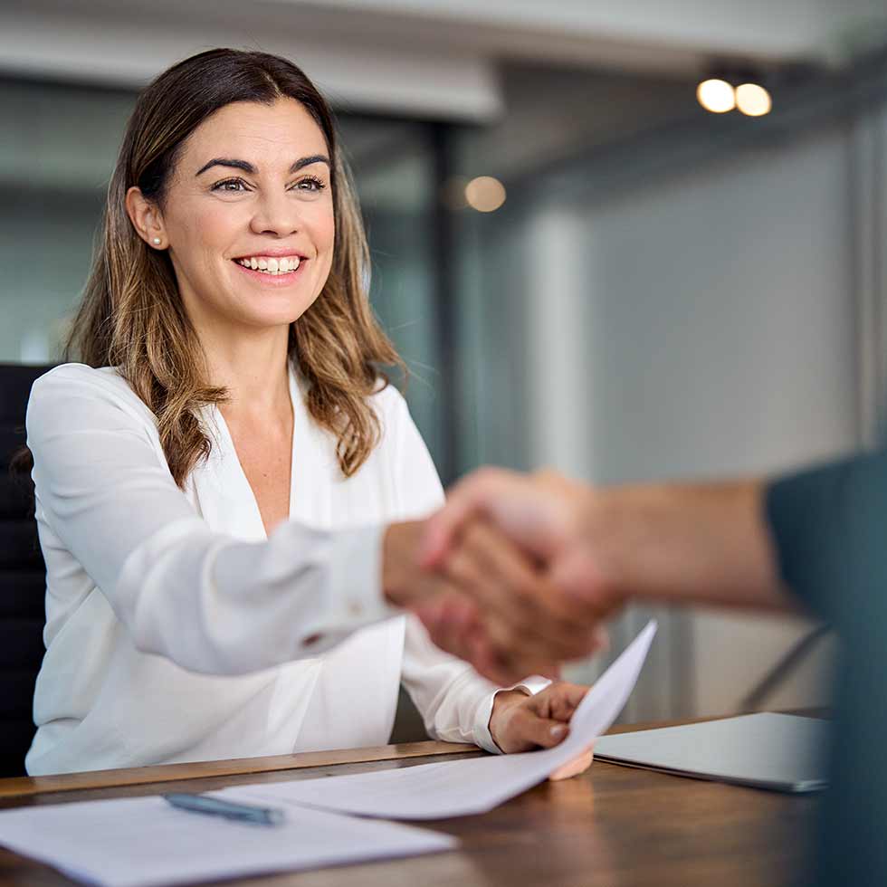 directory of professional services image - women shaking hands at desk